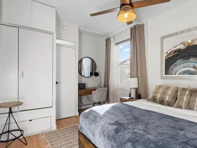 a bedroom with a bed and a desk and a window at Cozy 2 Bedroom 2 Bathroom with Parking in Toronto