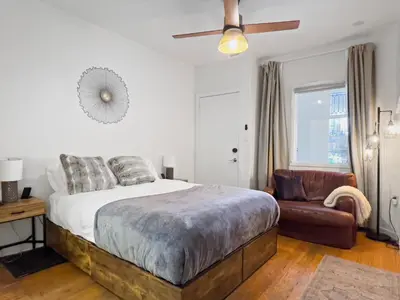 a bedroom with a bed and a couch and a chair at Cozy 2 Bedroom 2 Bathroom with Parking in Toronto