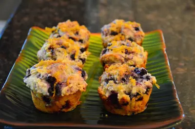 four muffins on a green plate on a table at Explorer House Bed & Breakfast in Niagara on the Lake