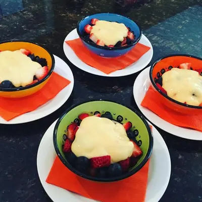 a group of bowls filled with fruit on plates at Explorer House Bed & Breakfast in Niagara on the Lake