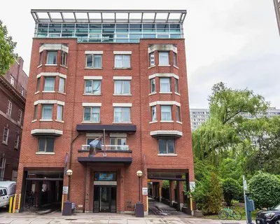 a tall red brick building with a glass at The Saint James Hotel, an Ascend Collection Hotel in Toronto