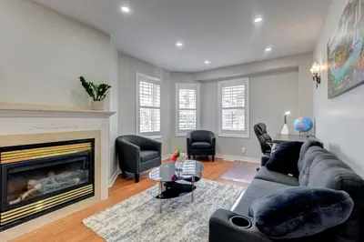 a living room with a couch and a fireplace at 4-BR Family Haven - Near Wonderland and Vaughan Mills in Vaughan