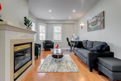 a living room with a couch and a fireplace at 4-BR Family Haven - Near Wonderland and Vaughan Mills in Vaughan