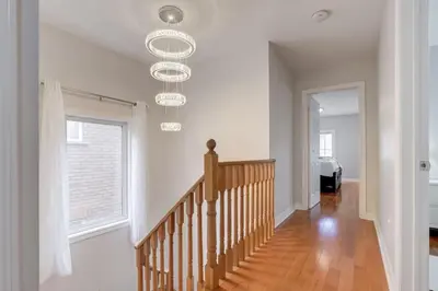 a staircase in a home with white walls at 4-BR Family Haven - Near Wonderland and Vaughan Mills in Vaughan