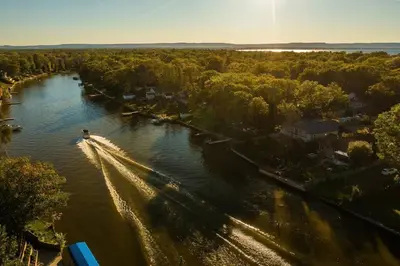 an aerial view of a boat on a river at Charming riverside cottage, walk to beach in Wasaga Beach