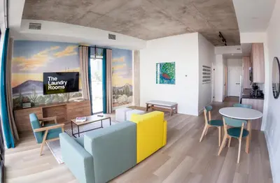 a living room with a couch and a table and chairs at The Laundry Rooms Augusta in Hamilton