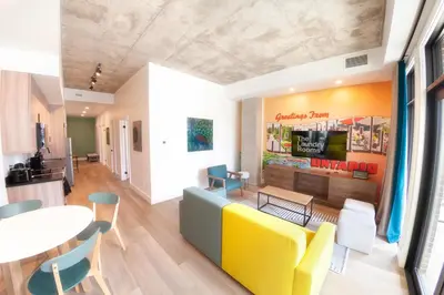 a living room with a yellow couch and a table at The Laundry Rooms Augusta in Hamilton