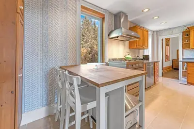a kitchen with a island in the middle of a room at Hidden Oasis with Hot Tubs, & Starry Fire Pits in Borden