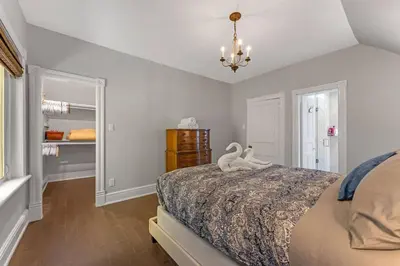 a bedroom with a bed with two swans on it at Hidden Oasis with Hot Tubs, & Starry Fire Pits in Borden