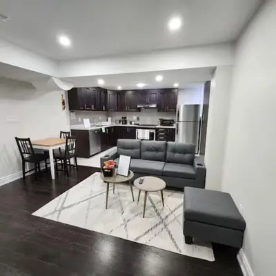 a living room with a couch and a table at Zen Nest in Brampton