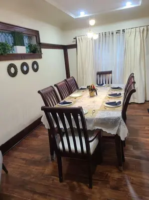 a dining room with a table with chairs and a tableablish at 3 BR House in Toronto Downtown in Toronto