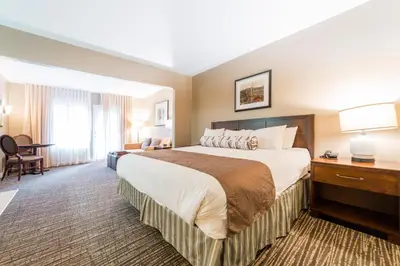 a hotel room with a large bed and a desk at Horseshoe Valley Suites - The Azure in Shanty Bay