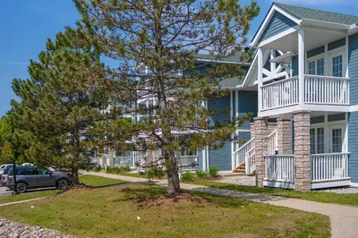 a house with a tree in front of it at Horseshoe Valley Suites - The Azure in Shanty Bay