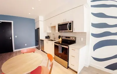 a small kitchen with a table and a microwave at The Laundry Rooms Gaslight Cambridge in Cambridge