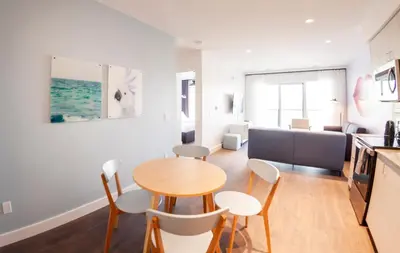 a kitchen and living room with a table and chairs at The Laundry Rooms Gaslight Cambridge in Cambridge