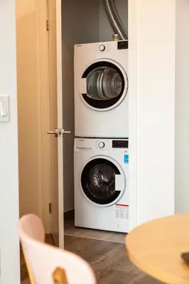 two washing machines and a washer and dryer in a room at The Laundry Rooms Station Park Kitchener in Kitchener