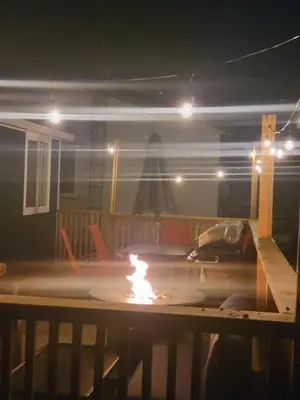 a fire pit in a garage at night at Stoneburg Cove Cottages in Carrying Place