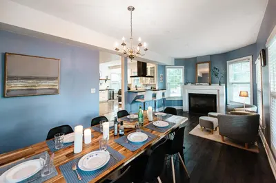 a dining room and living room with a table and chairs at Luxurious Lakeview Oasis in the Heart of Hamilton With Large Backyard in Hamilton