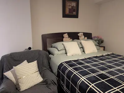 a bedroom with a bed with two teddy bears on it at Honey Dew in Bowmanville