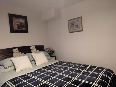a bedroom with a bed with two teddy bears on it at Honey Dew in Bowmanville