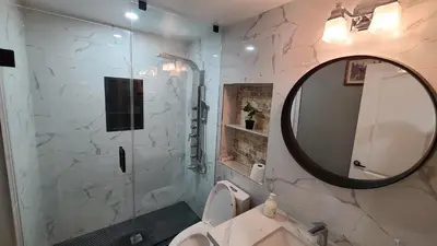 a bathroom with a toilet and a mirror at LUXURY 2-BEDROOMS UNIT WITH WIFI, LDR & PARKING. in Cambridge