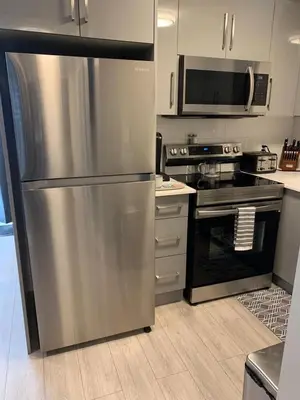 a kitchen with a stainless steel refrigerator and a microwave at Niagara Getaway across Fallsview in Niagara Falls
