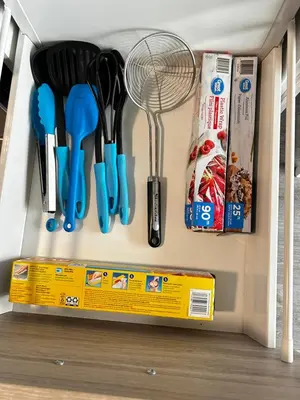 a drawer filled with kitchen utensils in a refrigerator at 1-bedroom condo near University of Waterloo in Waterloo