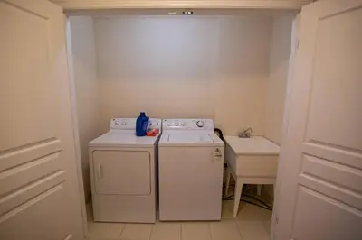 a small kitchen with a washing machine and a sink at Townhome Steps From Lake Ontario in Hamilton