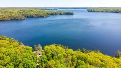 an aerial view of a lake in the woods at Lakefront Retreat Hot Tub Outdoor Sauna Dock Swim Stunning Views! in Rosseau