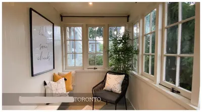 a room with windows and a chair and a table at Cozy Place on Main Floor in Toronto