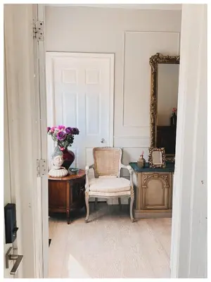 a room with a chair and a mirror and a table at Cozy Place on Main Floor in Toronto
