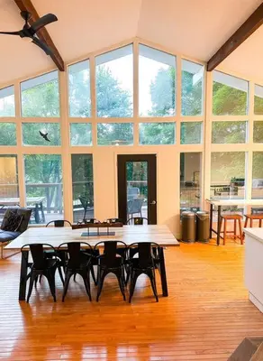 a large room with tables and chairs and windows at Waterfront Haliburton, All Season, Fully Equipped Cottage! in Haliburton