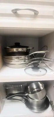 a shelf filled with pots and pans in a refrigerator at Cozy Home Close to Attractions in Niagara Falls in Thorold