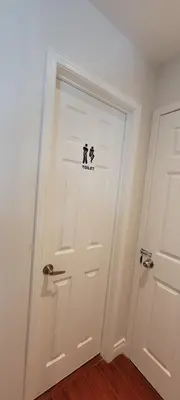 a white door with a dog sticker on it at Toronto Spacious Cozy Mainfloor Room in Toronto