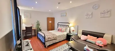 a living room with a couch and a bed at Toronto Spacious Cozy Mainfloor Room in Toronto