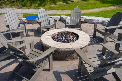 a group of chairs and a table and a fire pit at Horseshoe Valley Suites - The Maple in Shanty Bay