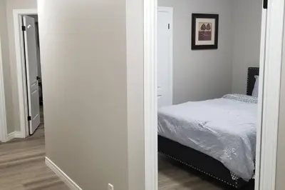 a bedroom with a bed in a white room at Cozy Luxurious Detached 4 Bedroom House in Guelph