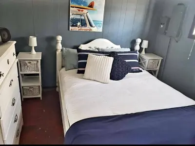 a bedroom with a large bed and two night stands at West Lake Waterfront Swimming - Free Pontoon Boat! in West Lake