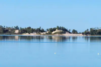 an island in the middle of a lake at West Lake Waterfront Swimming - Free Pontoon Boat! in West Lake