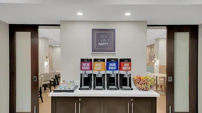 a counter with a bunch of wine bottles on it at Hampton Inn & Suites by Hilton Toronto Markham in Markham