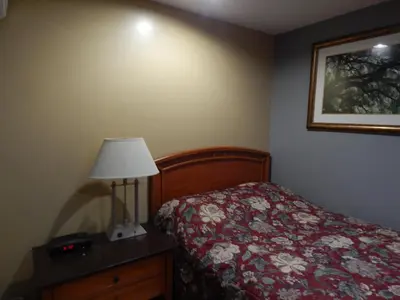 a bedroom with a bed and a lamp and a picture at Nox Hostel in Toronto
