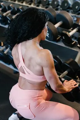 a woman with long black hair sitting in a gym at CN lovers in Toronto