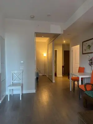 a living room with a table and a chair at Cozy holiday home in Toronto