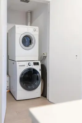 a washing machine and a washer in a room at Downtown Charm 2BR Retreat in Prime Location in Toronto