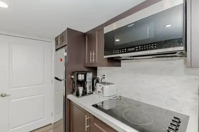 a kitchen with a counter top with a microwave at Luxury Basement Apartment in Oakville Monthly stays only in Oakville