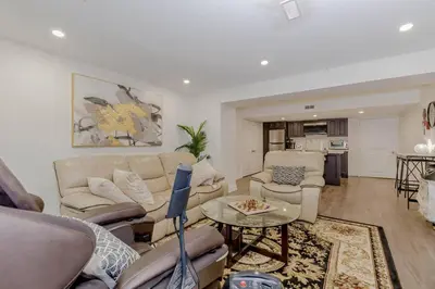 a living room with a couch and chairs and a table at Luxury Basement Apartment in Oakville Monthly stays only in Oakville