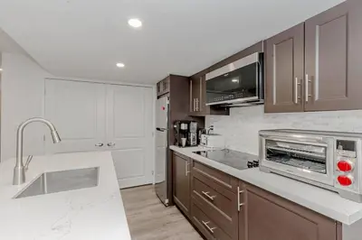 a kitchen with a sink and a microwave at Luxury Basement Apartment in Oakville Monthly stays only in Oakville