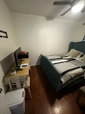 a bedroom with a bed and a desk with a computer at Spruce Lodge in London