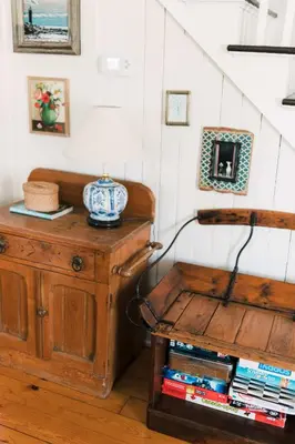 a room with a table with a lamp on top of a wooden cabinet at County Escape on Corey in Bloomfield