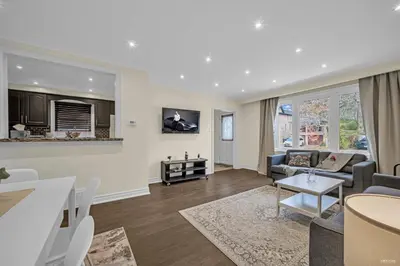 a living room with a couch and a table at Luxury Renovated House in Prime Location with Parking in Toronto